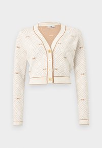 Κοντή κρεμ ζακέτα με μακριά μανίκια, μπεζ υφασμένο μοτίβο, χρυσά κουμπιά και ριμπ τελείωμα σε μανσέτες, στρίφωμα και λαιμό.