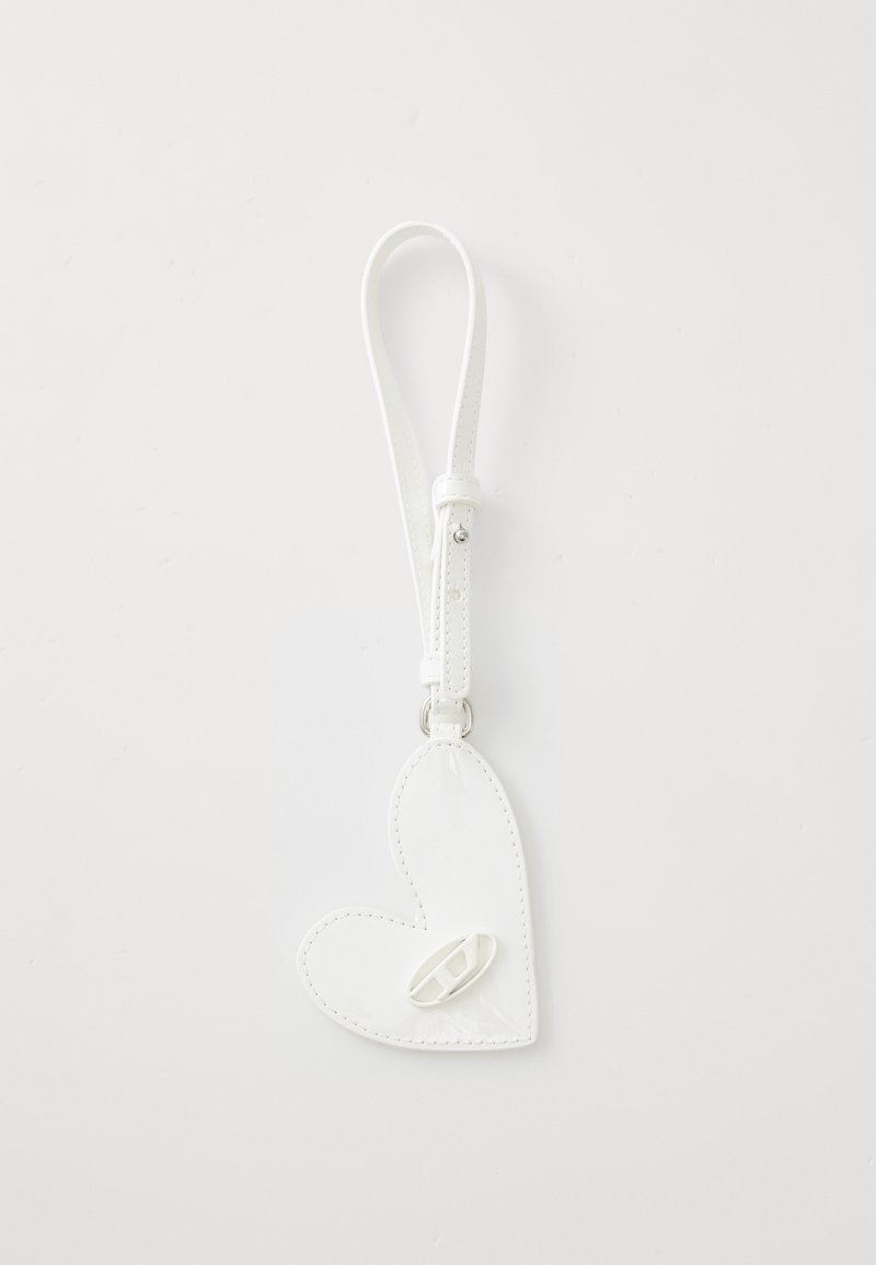 White heart-shaped leather keychain with a smooth texture, featuring a strap and a small loop attachment.