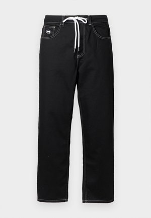 Black trousers with a straight-cut design, featuring white stitching, an adjustable waistband with a drawstring, and side pockets.