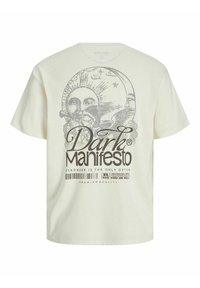 T-shirt di cotone color crema con una grande stampa grafica di un sole e testo. Design morbido e ampio con maniche corte e scollatura rotonda.