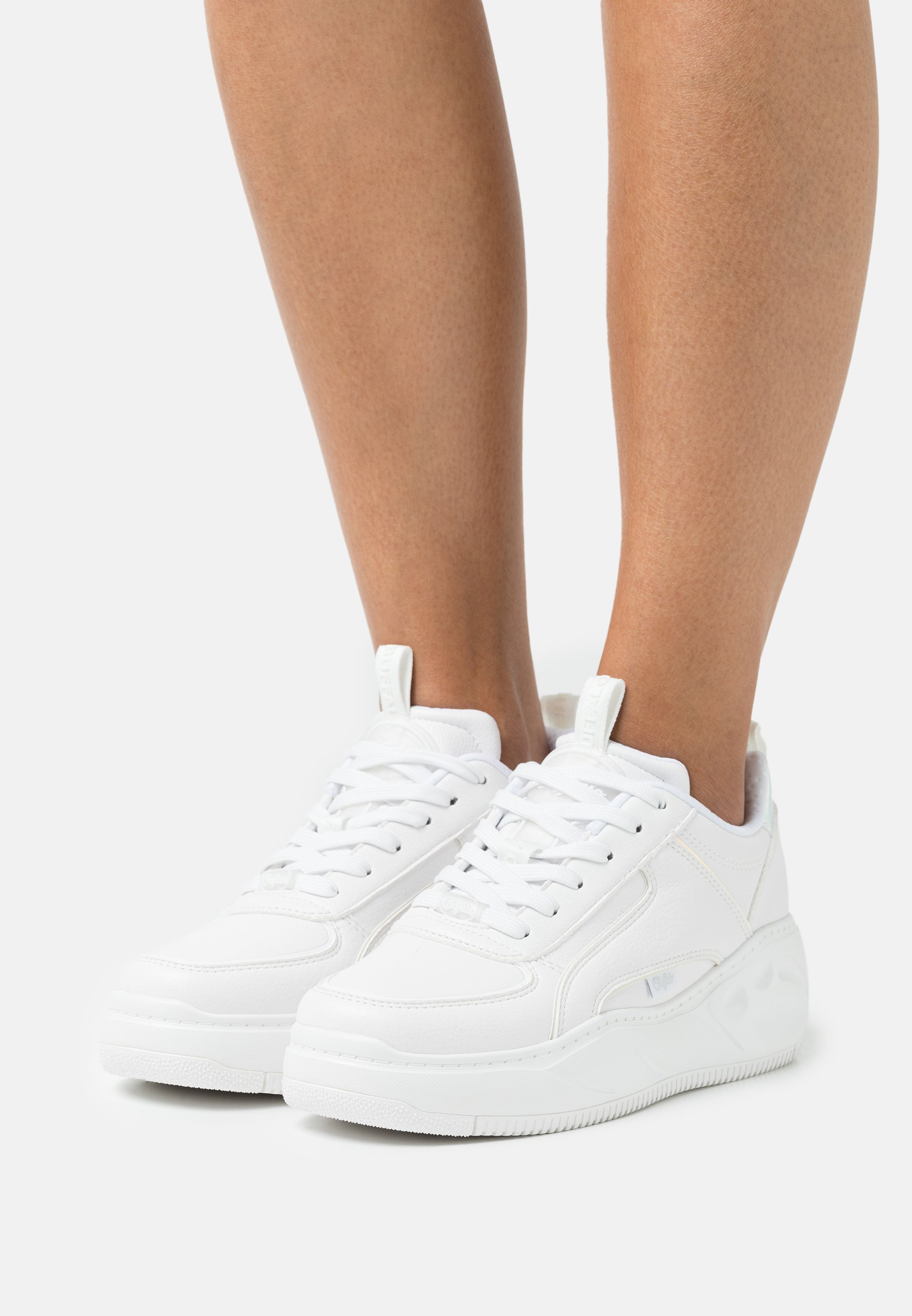 white flat trainers