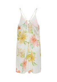 Robe d'été blanche sans manches avec bretelles nouées dans le dos et grand imprimé floral jaune, rose et vert, longueur moyenne et tissu léger.