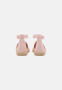 Roze katoenen espadrilles met een gevlochten juten zool, open hiel en verstelbare band voor een stevige pasvorm. Soepele textuur en lichtgewicht ontwerp.