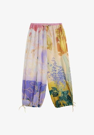 Pantalon ample à fleurs avec une taille élastique et des cordons réglables aux chevilles, aux tons pastel rose, violet, jaune et vert.