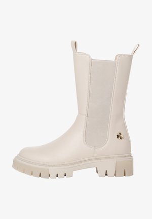 Crème-kleurige enkellaars met een gladde leren afwerking, elastische zijkanten, gouden bloemenaccent en een stevige rubberen zool.