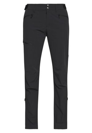 Pantalones exteriores negros hechos de material ligero, con múltiples bolsillos con cremallera, una textura suave y un diseño ajustado.
