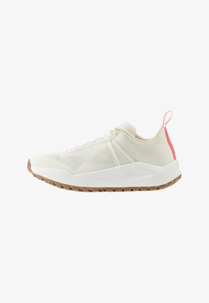 White athletic shoes with a mesh upper, featuring a pink accent at the heel and a textured rubber sole with traction patterns.