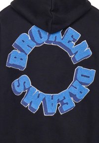 Black hooded sweatshirt featuring a large, circular, textured design with the words "BROKEN DREAMS" in gradient blue and light blue letters.