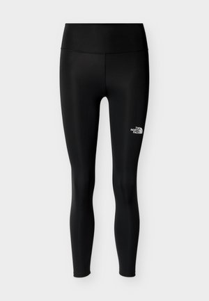 Fekete, rugalmas anyagból készült leggings, magas derékrésszel és egy kis fehér logóval a bal alsó lábszáron. Egységesen sima felület.