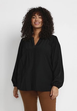 Zwarte blouse met lange mouwen, V-hals en geplooide schouders. Gemaakt van textuurstof, met een losse pasvorm en elastische manchetten.