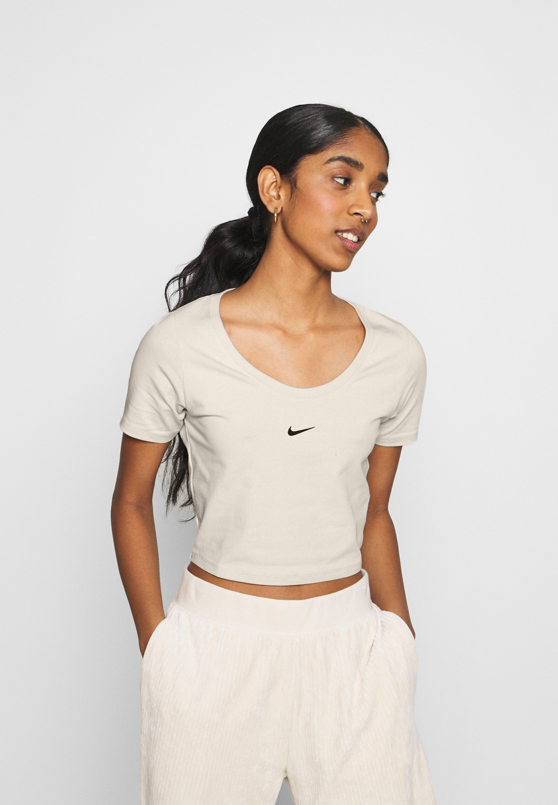 beige nike crop top