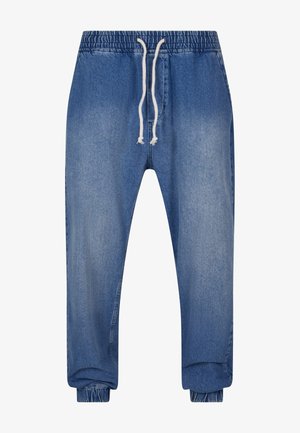 Denim joggebukser med elastisk liv, justerbar snor og elastiske mansjetter. Har en lys blå vask og glatt tekstur.