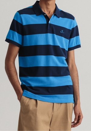 Blue and navy striped polo shirt with a collar and short sleeves, featuring subtle brand logo and a soft, textured cotton material.