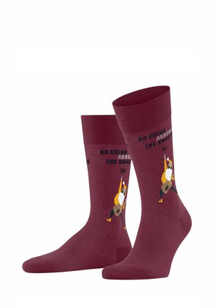 Calzini bordeaux con un personaggio dei cartoni animati che suona la chitarra. La scritta recita "ROCKING AROUND THE XMAS." Composti da un tessuto morbido e elasticizzato.