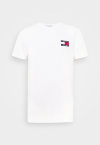 Bílá bavlněná trička s krátkým rukávem. Obsahuje malé obdélníkové logo v námořnické modři, červené a bílé barvě na levé části hrudi. Klasický design s kulatým výstřihem.