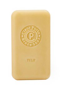 Bar of soap, rectangular shape, light yellow color with a smooth texture. Features embossed logo and "TULIP" in gold lettering.