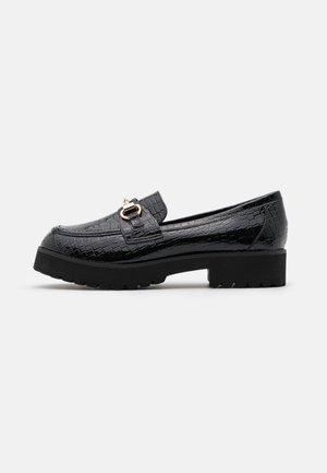 Black patent leather loafers with a crocodile texture, gold-tone hardware accent, and a chunky black sole. Simple slip-on design.