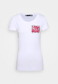 Vit kortärmad T-shirt med en färgglad "Love Moschino" grafisk design med blommiga accenter på bröstet. Tillverkad av mjukt bomullsmaterial.
