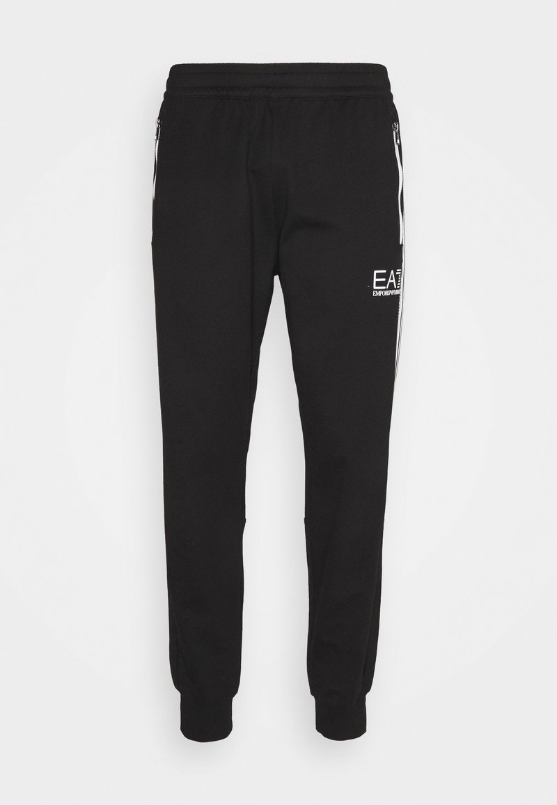Svarta joggers med elastisk midja och mudd, med sidofickor med dragkedja och vitt logotyp på vänster lår. Tillverkade av ett mjukt tyg.