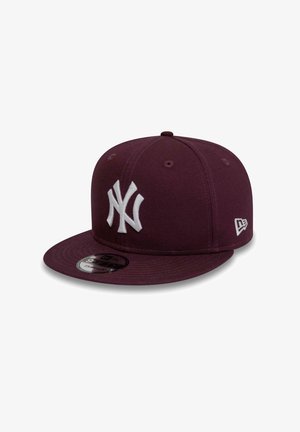 Dark purple New York Yankees snapback cap with flat brim and white embroidered logos on front and side.