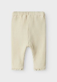 Cremefarvede ribbede leggings med et struktureret stof, der har en elastisk talje og en flæset kant nederst på benene.