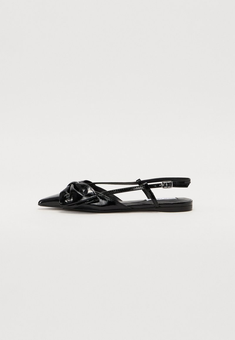 Black patent leather slingback shoe with pointed toe, knotted detail on the upper, and flat sole. Features thin straps and adjustable buckle.