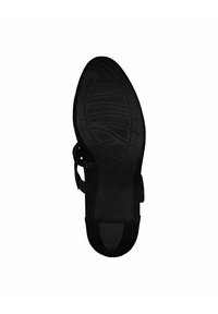 Suela de sandalia negra con agarre texturizado, que presenta un acabado suave, forma contorneada y recortes para transpirabilidad.
