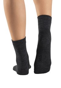 Dark gray ankle socks with a ribbed cuff and reinforced heel, featuring a soft texture and a logo printed on the side.