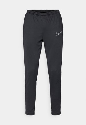 Nike schwarze Sporthose mit elastischem Taillengummi, schmal zulaufenden Beinen und einem weißen Logo auf der linken Seite. Glatte Stoffqualität ohne sichtbare Muster.