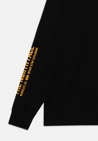 The North Face TEEN VARSITY GRAPHIC OVERSIZE UNISEX - Long sleeved top - black