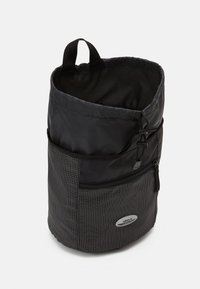 Black fabric bucket bag with a checkerboard pattern, drawstring closure, front zip pocket, and a top handle for easy carrying.