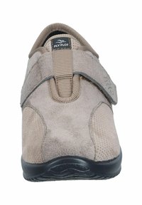 Beige slip-on shoe made of suede with a textured mesh panel, featuring a front strap closure and a black rubber sole.