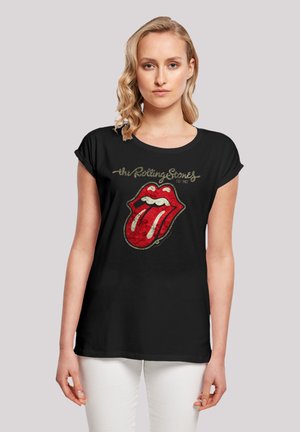 Black cotton t-shirt featuring a distressed, vibrant red lips design associated with the Rolling Stones, short sleeves, and round neckline.