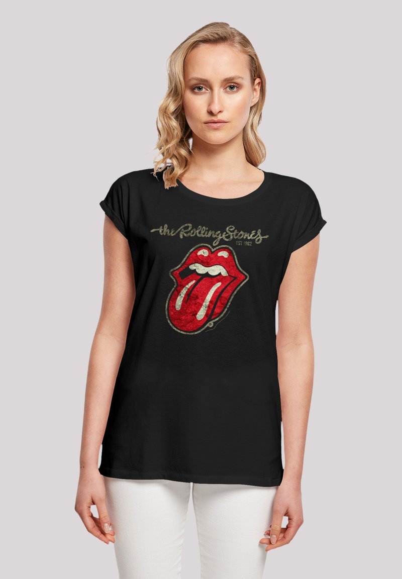 Zwart katoenen t-shirt met een verweerd, levendig ontwerp van rode lippen geassocieerd met de Rolling Stones, korte mouwen en een ronde halslijn.