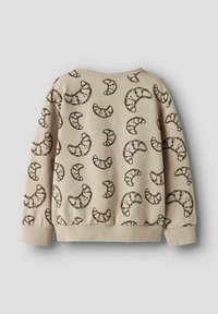 Sweatshirt beige avec un motif de croissants répétés en marron foncé, avec un col rond et des poignets et un ourlet côtelés.