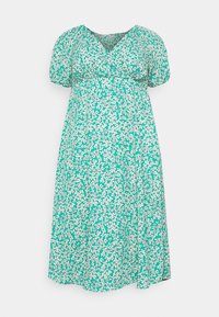 Grünes Blumenkleid mit V-Ausschnitt, kurzen Puffärmeln und lockerer Passform. Mit einem weißen Blumenmuster auf einem strukturierten Stoff.