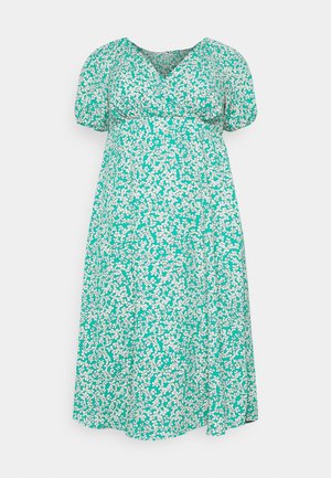 Zielona sukienka w kwiaty z dekoltem w serek, krótkimi bufkami i luźnym krojem. Posiada biały wzór kwiatowy na teksturowanym materiale.