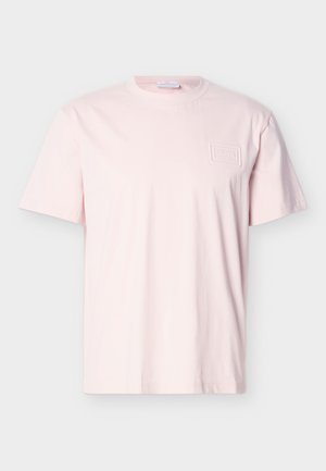 Light pink short-sleeve crew neck t-shirt with a small rectangular embossed logo patch on the left chest.