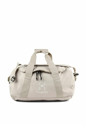 Beige Haglöfs duffelbag met dubbele handvatten, voorvak met ritssluiting, verstelbare schouderriem en logo middenvoor.