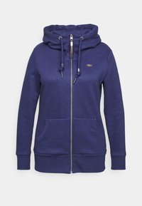 Marineblauwe rits hoodie van zachte stof. Heeft een hoge kraag, een trekkoord met metalen uiteinden en twee voorzakken.