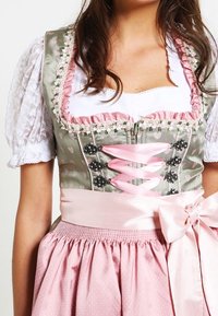Traditional dirndl with a grey bodice, pink satin laces, and floral accents. Features white puffy sleeves and a pink skirt with dots.