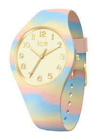 Montre en silicone multicolore avec un cadran doré, un fond crème et de grands marqueurs numériques ; elle possède un bracelet dégradé pastel et de simples aiguilles dorées.