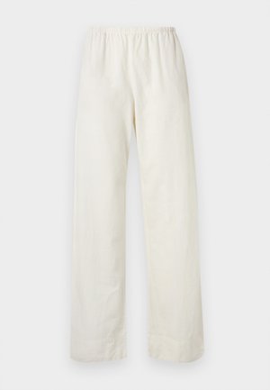 Pantalon ample de couleur crème avec une taille élastique et des jambes droites sur un fond clair uni.