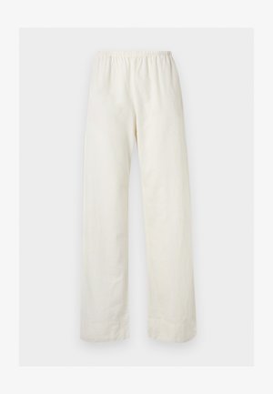 Pantalon ample de couleur crème avec une taille élastique et des jambes droites sur un fond clair uni.