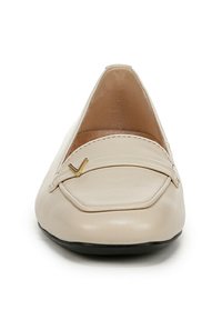 Mocassino in pelle beige con punta rotonda strutturata, cuciture decorative e un sottile accento dorato sulla parte superiore. Suola piatta.