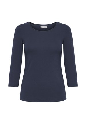Tmavomodrý dlhý rukáv z mäkkej látky. Má okrúhly výstrih a úzky strih s hladkou textúrou a minimálnym prešívaním.