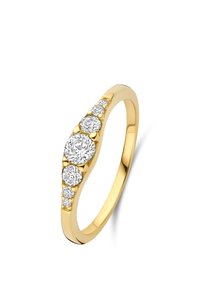 Gold band ring featuring a graduated row of seven round-cut diamonds set along the top half of the band.