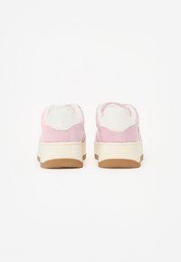 Scarpe in suede rosa con accenti bianchi, colletto morbido e suola di gomma crema. Presentano una suola in gomma testurizzata per una migliore presa.