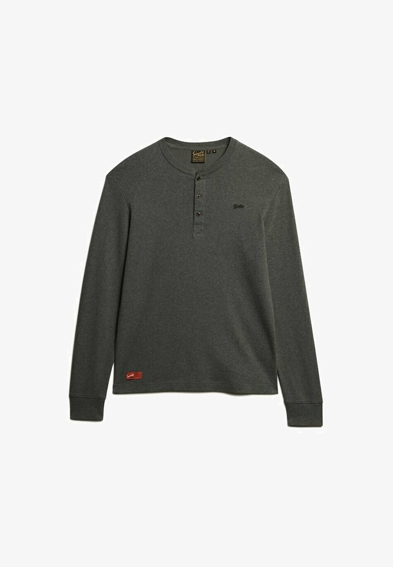 Langärmliges, dunkelgraues Henley-Shirt aus weichem Stoff. Verfügt über eine Knopfleiste, gerippte Bündchen und ein kleines Logo auf der Brust.