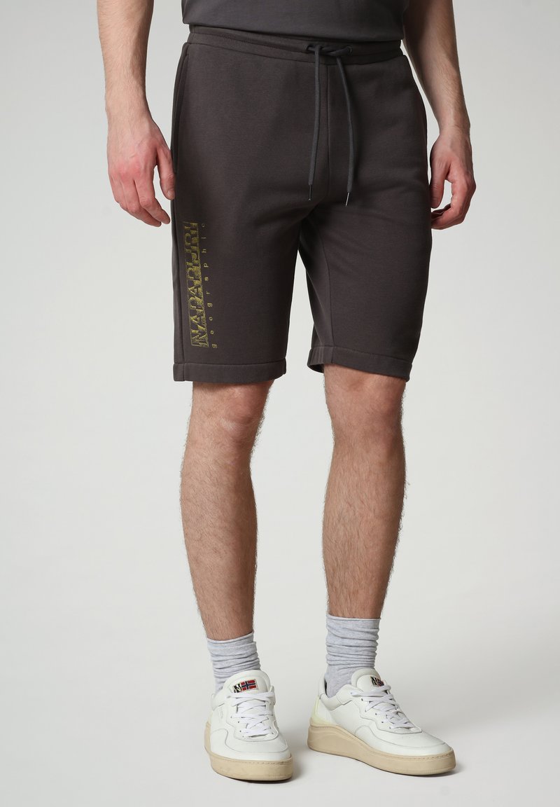Shorts in cotone grigio scuro con vita regolabile tramite cordino, con un logo dorato stampato sulla gamba sinistra e orli risvoltati.